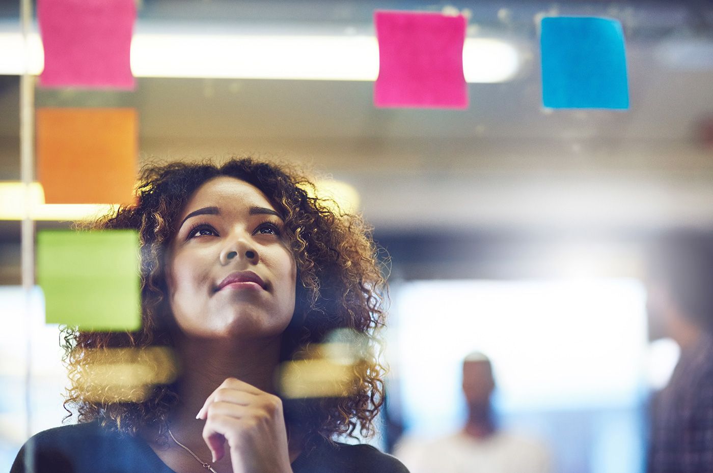 young-woman-brainstorming-and-using-sticky-notes