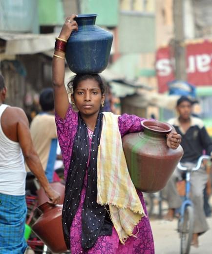 Indian woman holding two pots