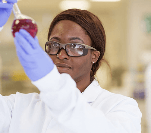 Young woman in a lab doing an experiment