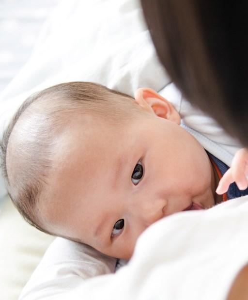 Infant child looking up at its mother