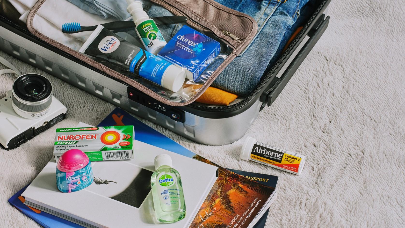 Reckitt brands' products spill out of a suitcase packed for a holiday - Nurofen, Durex, Veet, Airborne, Dettol and Gaviscon